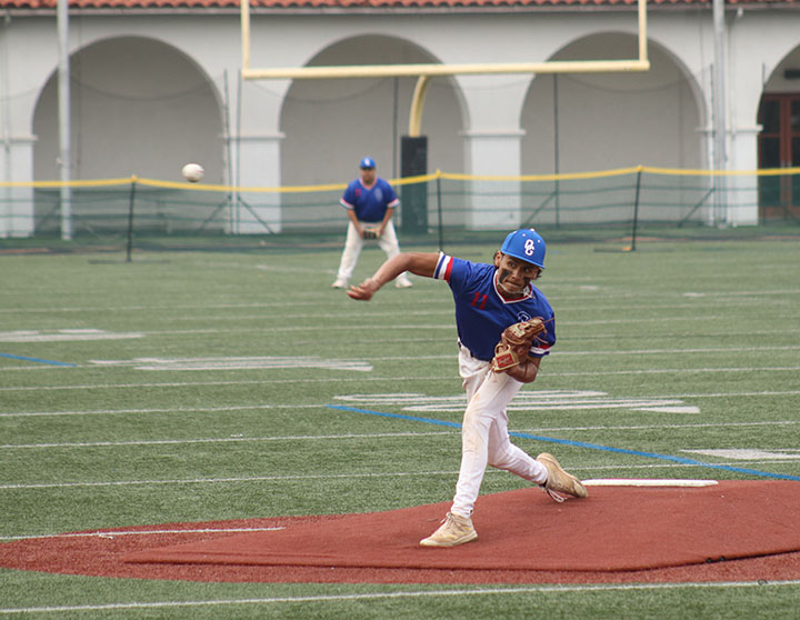 STRIKE! Hurling his pitch toward the plate, Adrian Garcia, 12, aims for the strike zone. 