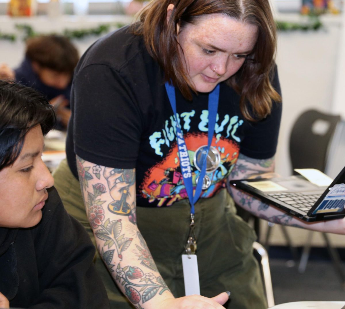 Let’s work on it together!
English teacher, Katelynn Beamish-Sanchez helps Hugo Escalante,9, find the correct article on his computer.
The Project Based Learning Credit Recovery class is a small group of students. Escalante says he likes the small class size since Beamish can check up on them more often.
