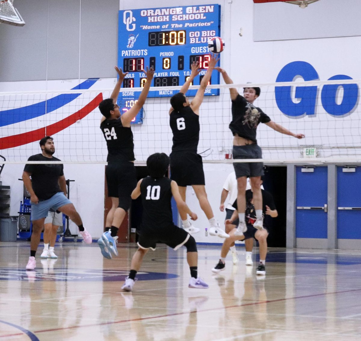 Kill it. During the alumni game, boys volleyball prepares to dig a tip from the alumni team. 