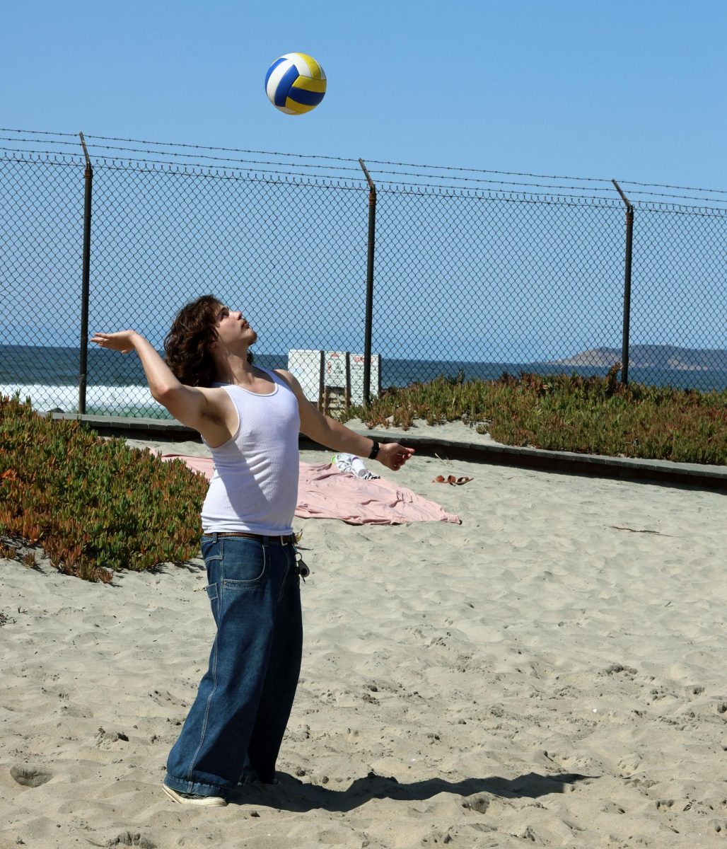 Logan Kennedy, 12, prepares a serve to the opposing team to keep the game alive and share memories from camp surf.
