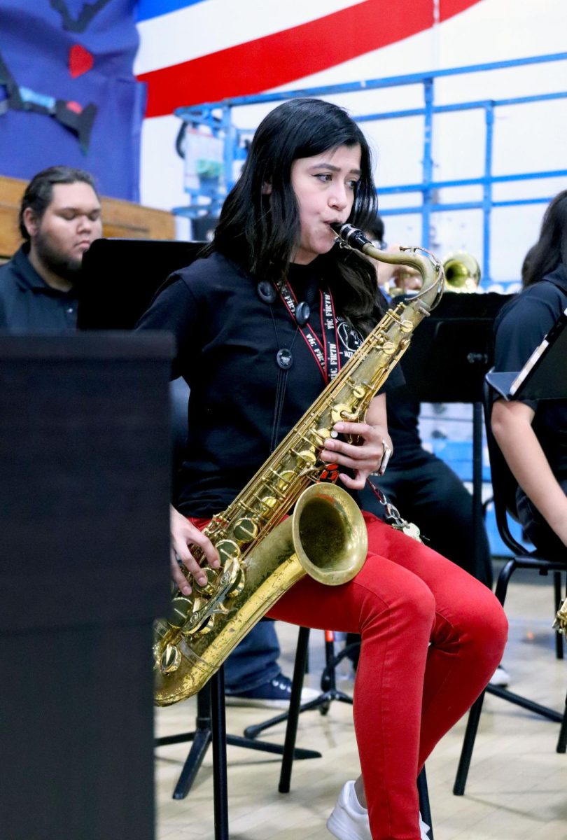 Reed it. Band teacher Claire Tongpalad plays the  saxophone next to her students at the rally on may 21. Bringing back old memories Tongpalad felt like she was back to when she was younger. 
“I surprised my students with playing besides them and it just brought memories from when I was in high school,” Tongpalad, said.
Hiding in the students, she almost looked as if she was one of them. Photo By Sofia Melchor.