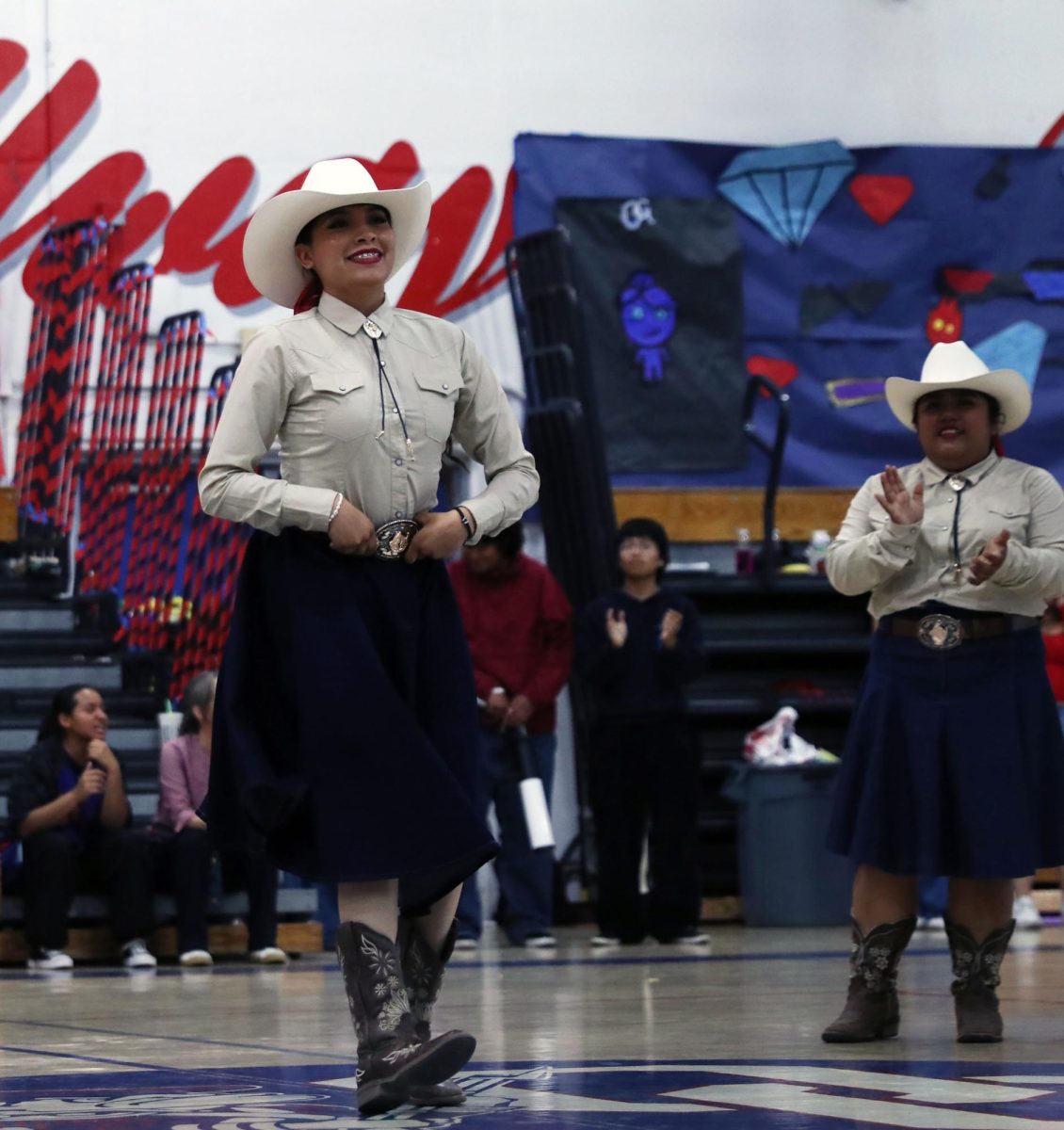 A BAILAR! To start off the rally on May 21, baile folklorico did a dance getting the crowd rowdy. 
“I love dancing and getting to show out for the school hearing the screams makes the moment better,” Yesenia Correa, 11, said. 
Correa dances away tapping her boots while her group members cheered her own putting a smile on correa’s face. Photo By Azul Rios.