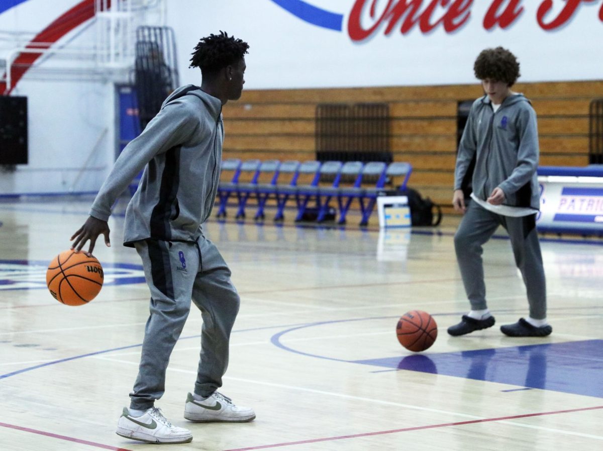 Locked in. Concentrated on preparing to shoot , Xadan Wilde, 10, watches his teammate before making the shot. While warming up before their game against Rock Academy, the boys basketball team practiced by playing in small groups. “Once we get into the season, it’s not so much individual skill work. It’s understanding how to work as a team and understand our concepts,” Varsity Boys Basketball coach, Roman Macias said. The team practiced a week before every game so they could be ready to work together. Photo by Amber Cardenas.