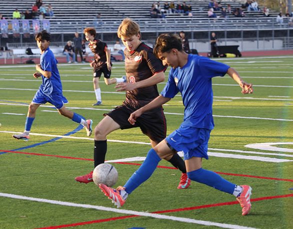 Fight on! Travelling across the field, Benjamin Resendez, 11, juggles the ball with himself, soon to be stolen by the opposing team. Resendez takes the ball after Marco Sarabia, 11, passes the ball to him. Escondido Charter soccer player soon kicks the ball from Resendez and takes advantage. “I lost some hope, realizing our team wasn’t able to score a goal in this half of the game,” Resendez said. For the first 45 minutes of the game, the game was tied at 0-0. Photo by Richie Martinez.