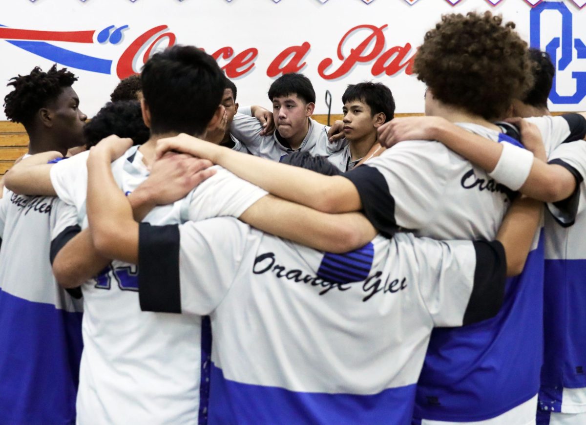 Circle of trust. Athletes huddle up together for a team prayer before their match. Markus Maramba, 10, and Anthony Trejo, 10, look to their teammates reassuringly as they follow with the prayer. The team is very close with one another. To them, these prayers are natural and boost their morale. “I pray before a game. Even just a short prayer keeps me calm and confident,” Maramba said. On the court, they’re teammates, but when it comes to being outside of sports and school, these players have grown together and gotten closer, looking towards each other for support and encouragement. Photo by Azul Rios.