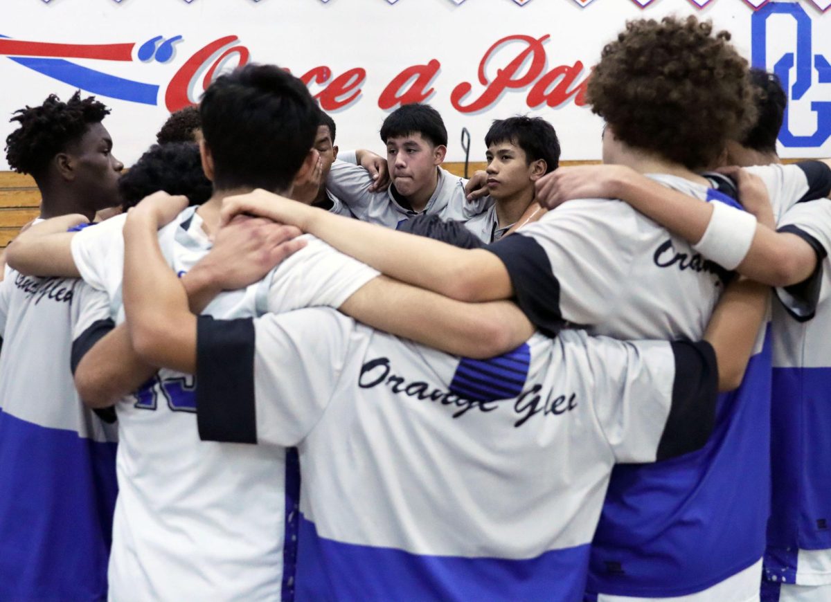 Huddle up! Gathered together, Anthony Trejo, 10, Markus Maramba, 10, and the boys basketball team huddled to talk before the game. They shared words of encouragement and prayed together before their game began. “I feel like the basketball team in general has always been super tight knit and close,” Varsity Basketball Assistant Coach, Brian Gallo said. Noah Reynoso, 12, saw the team get along really well and the players offer support to one another on and off the court. Photo by Azul RiosChavez.